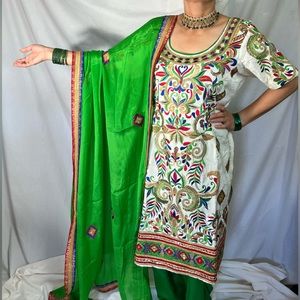Embroidered Indian salwar suit in green and white color.